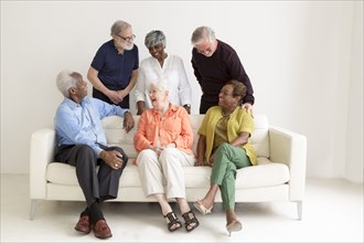 Older people laughing on sofa