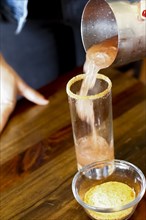 Woman pouring cocktail into the glass