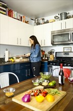 Woman chopping vegetables in kitchen