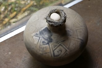 Egg in nest on vase