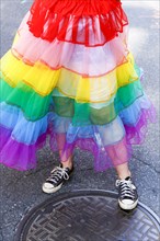 Person wearing rainbow skirt