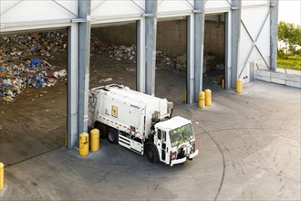 Garbage truck unloading trash