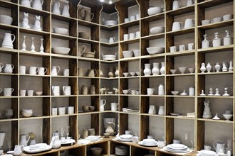 White ceramic pottery on shelves in store