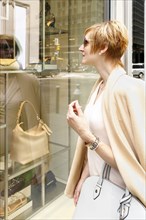 Glamorous Caucasian woman window shopping