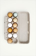 Colored eggs in egg carton