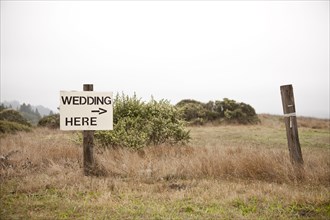 Post in field with sign - Wedding here