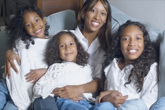 African American mother with daughters smiling