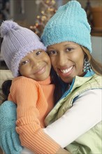 African American mother and daughter wearing winter hats