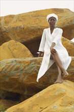 African American woman sitting on rocks