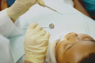 High angle view of dentist working on African boy