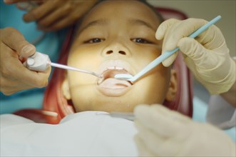 Dentist working on young African boy