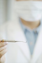 Close up of dental tool in dentist's hand