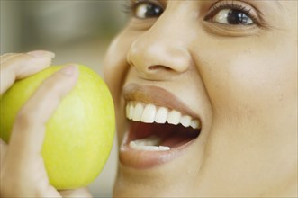 Close up of woman about to bite into an apple