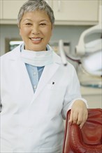 Senior Asian female dentist smiling