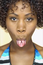Close up of African woman sticking out tongue