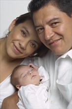 Portrait of Hispanic parents and baby