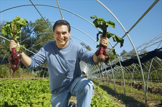 Hispanic man holding organic produce