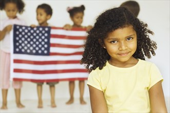 Multi-ethnic children holding American flag