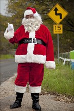 Santa hitchhiking at roadside