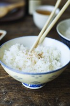 Bowl of rice and chopsticks
