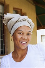 Smiling mixed race woman wearing turban