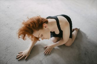 Caucasian woman kneeling on floor