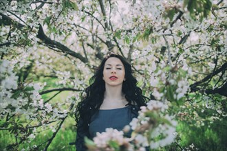 Caucasian woman standing near flowering tree