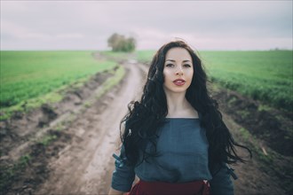 Caucasian woman standing on dirt path