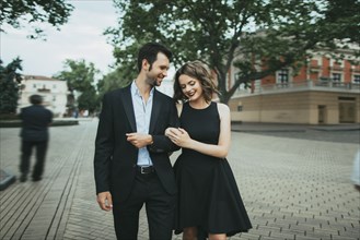 Smiling Caucasian couple walking arm in arm