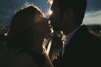 Caucasian couple kissing at night
