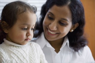 Indian woman smiling at daughter