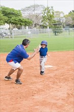 Hispanic coach and young baseball player