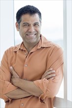 Hispanic man smiling in window