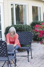 Caucasian woman using laptop outdoors