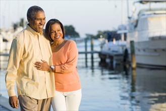 African American couple smiling at pier