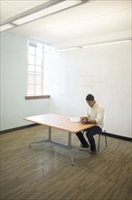 Asian businessman working in empty office
