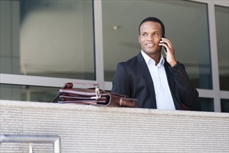 Black businessman talking on cell phone