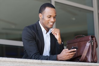 Black businessman using cell phone