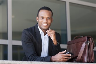 Black businessman using cell phone