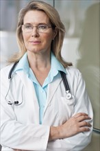 Caucasian doctor standing with arms crossed