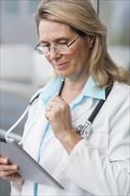 Close up of Caucasian doctor using digital tablet