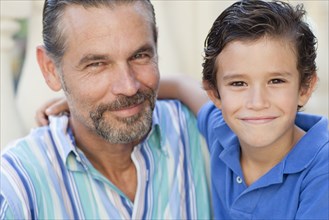 Close up of Caucasian father and son hugging