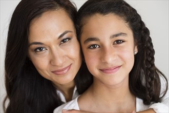 Close up of mother and daughter hugging