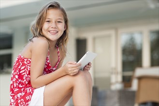 Caucasian girl using digital tablet outdoors