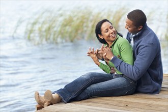 Smiling couple hugging at dock