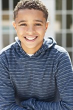 Close up of mixed race boy smiling outdoors