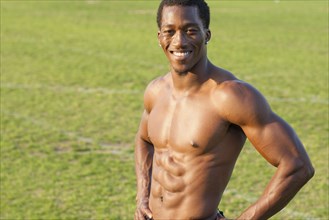 Black athlete smiling on sports field