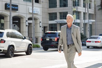Caucasian businessman walking in city