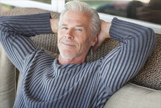 Caucasian man relaxing on sofa