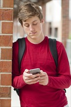 Caucasian teenage boy using cell phone